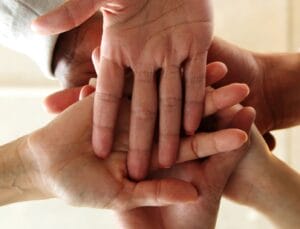business people teamwork in an office with hands together